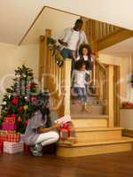 Young African American family on Christmas morning