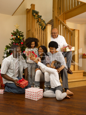 African American family exchanging Christmas gifts