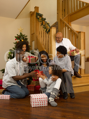 African American family exchanging Christmas gifts