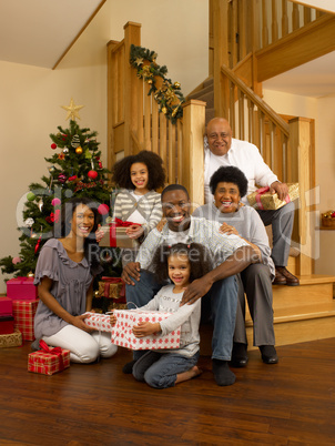 African American family with Christmas tree and gifts