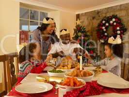 Mixed race family having Christmas dinner