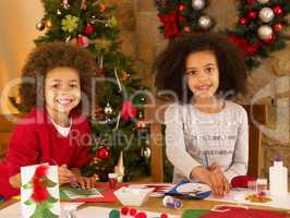 Mixed race children making Christmas cards