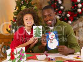 African American father and mixed race son making Christmas card