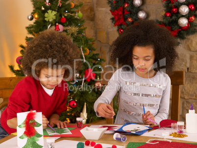 Mixed race children making Christmas cards