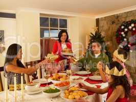 Hispanic family having Christmas dinner