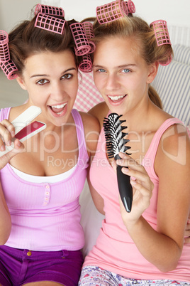 Teenage girls with hair in curlers