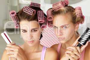 Teenage girls with hair in curlers