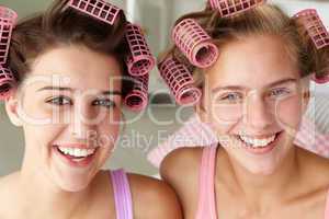 Teenage girls with hair in curlers