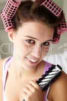 Teenage girl with hair in curlers