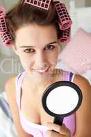 Teenage girl with hair in curlers