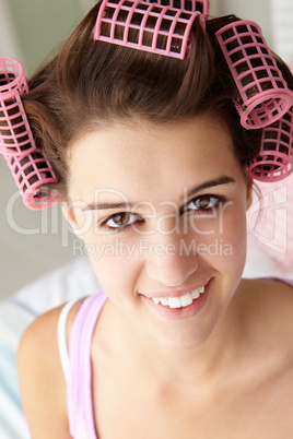 Teenage girl with hair in curlers