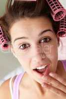 Teenage girl with hair in curlers