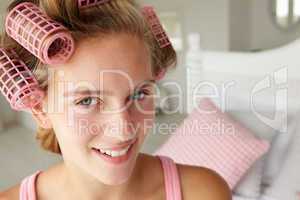 Teenage girl with hair in curlers
