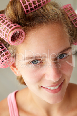 Teenage girl with hair in curlers