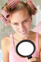 Teenage girl with hair in curlers