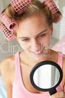 Teenage girl with hair in curlers