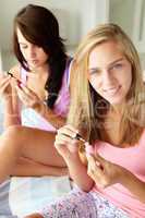 Teenage girls painting nails