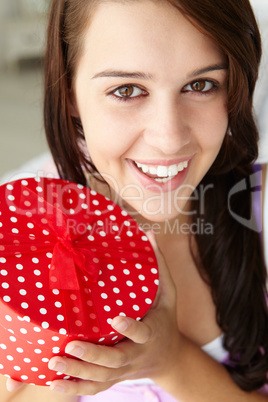 Teenage girl holding gift box