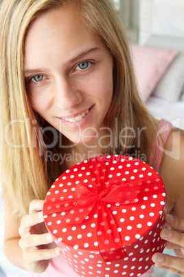 Teenage girl holding gift box