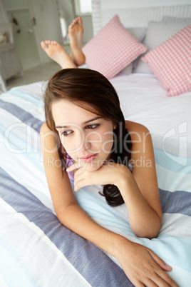 Teenage girl lying on bed