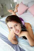 Teenage girl relaxing on bed