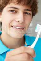 Teenage boy with toothbrush