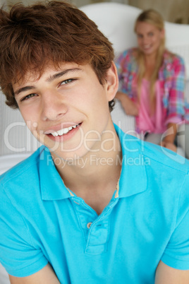 Teenage boy and girl in bedroom