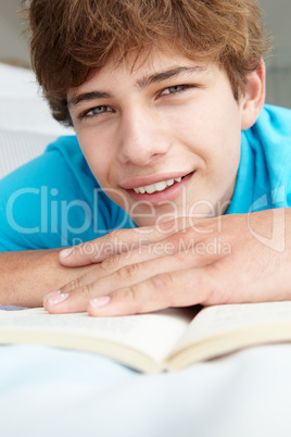 Teenage boy reading a book