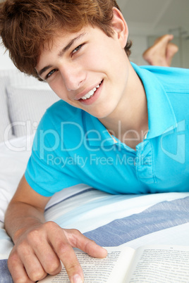 Teenage boy reading a book