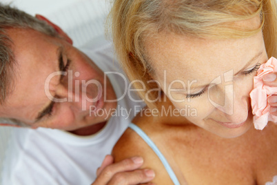 Man comforting crying wife