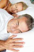 Head and shoulders mid age couple sleeping