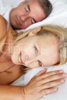 Mid age couple in bed woman awake