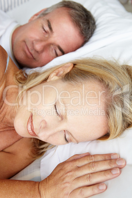 Head and shoulders mid age couple sleeping