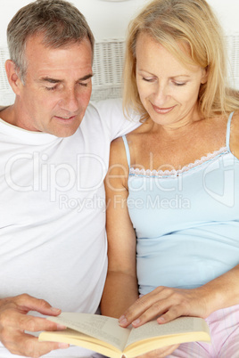 Mid age couple reading together