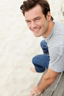 Portrait man sitting by beach