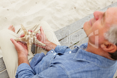 Senior man holding starfish