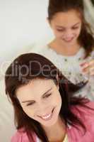 Girl brushing mother's hair