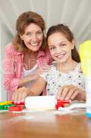 Young girl baking with grandmother