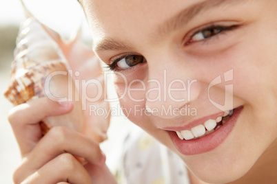 Young girl with seashell