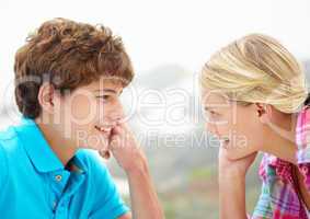 Teenage girl and boy head and shoulders in profile