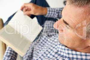 Mid age man reading a book