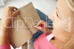 Senior woman writing in notebook