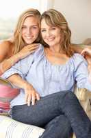 Mid age woman and teenage daughter at home