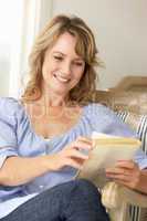 Mid age woman reading a book
