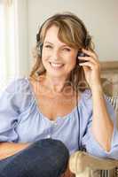 Mid age woman wearing headphones