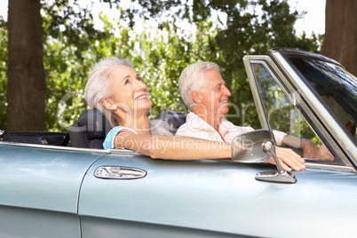 Senior couple in sports car