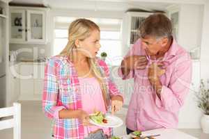 Father making teenage daughter do chores at home