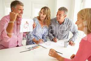 Mid age couples painting with watercolors