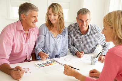 Mid age couples painting with watercolors