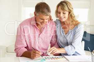 Mid age couple painting with watercolors